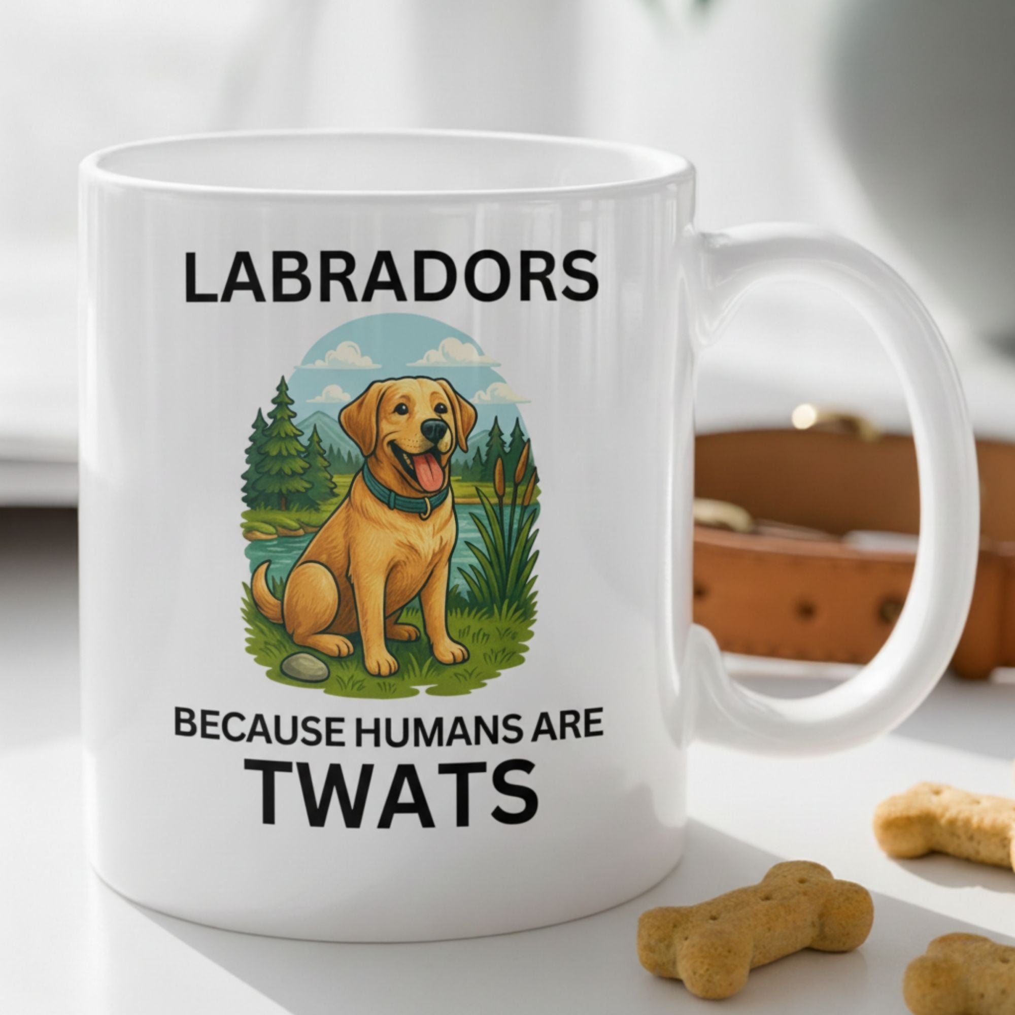 White mug with a Labrador illustration and text on a table with dog treats.