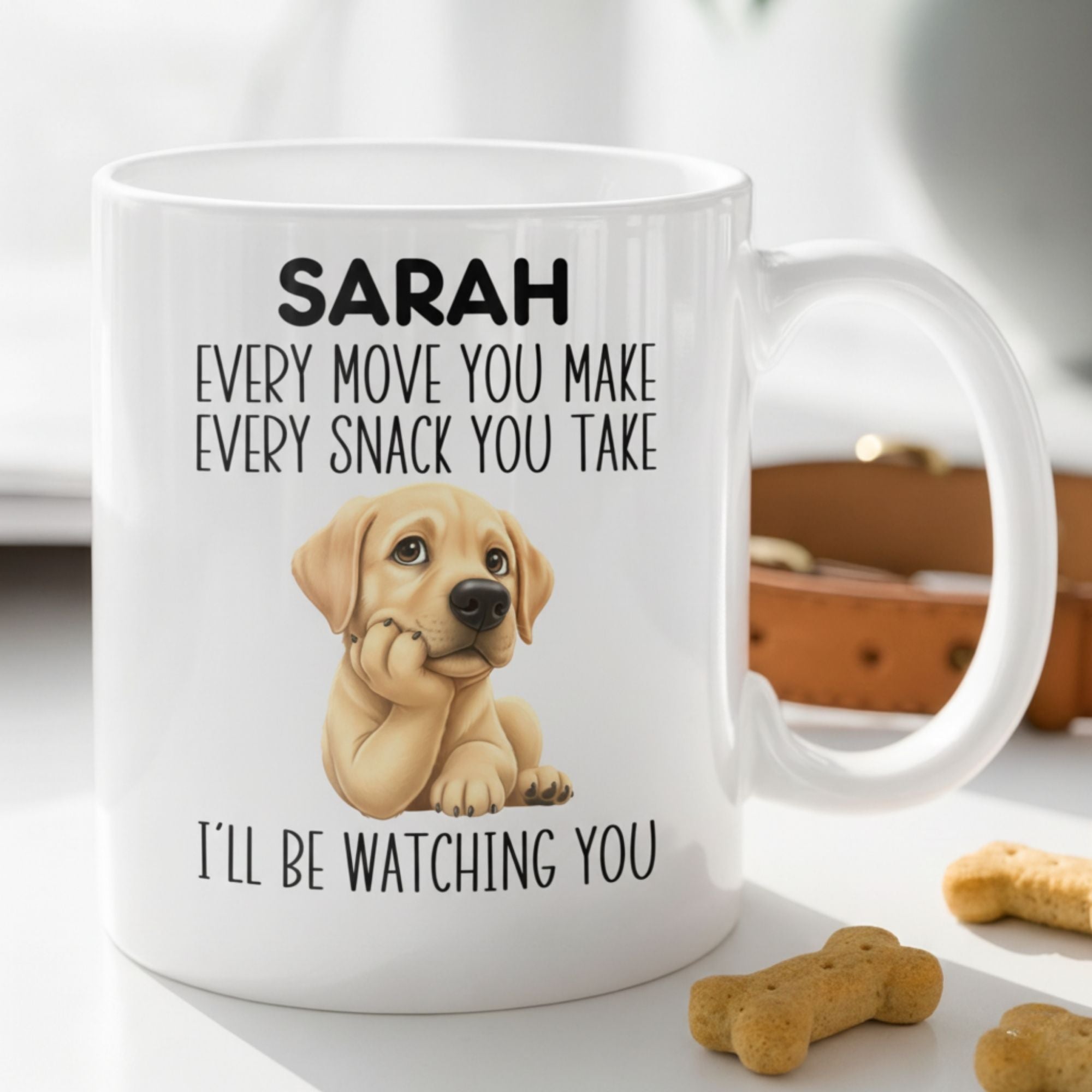 White mug with a puppy graphic and text on a white surface with dog treats.