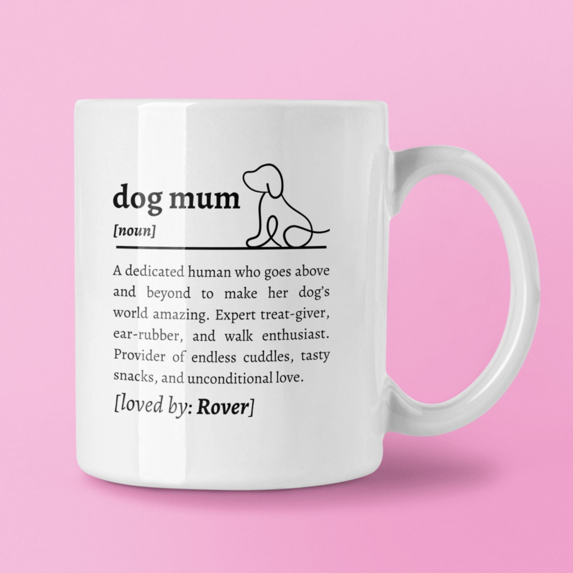 White mug with text definition of 'dog mum' on a pink background