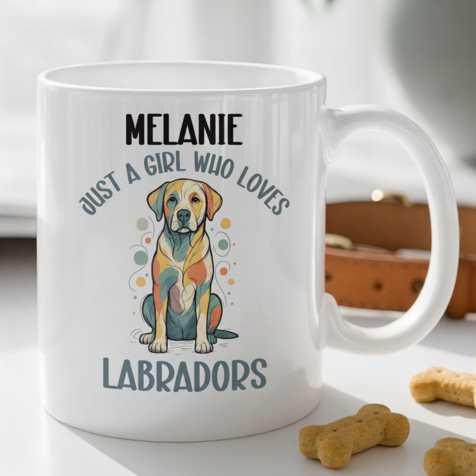 White mug with a colorful dog illustration and text on a white surface with dog treats.