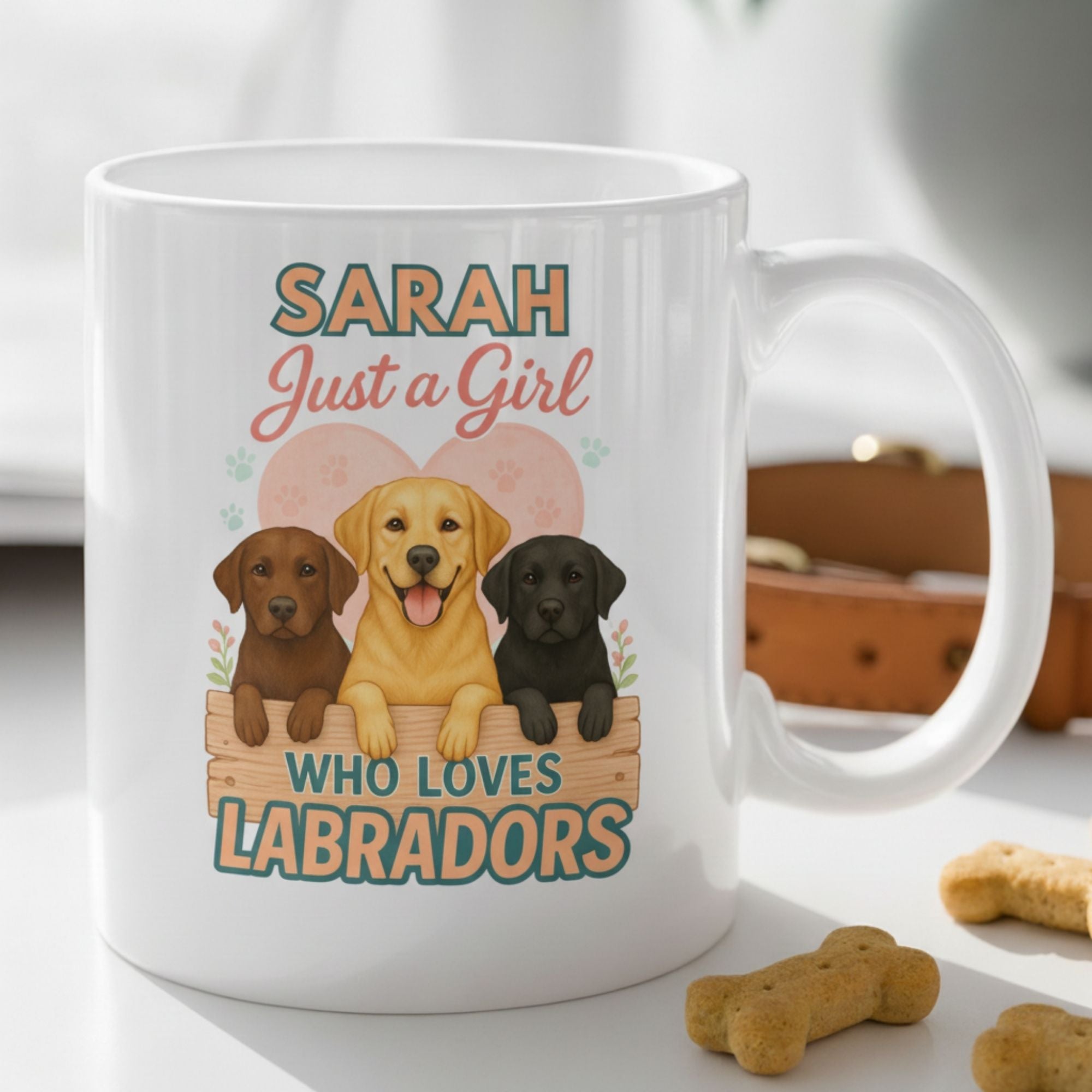 White mug with Labrador illustrations and text on a surface with dog treats.