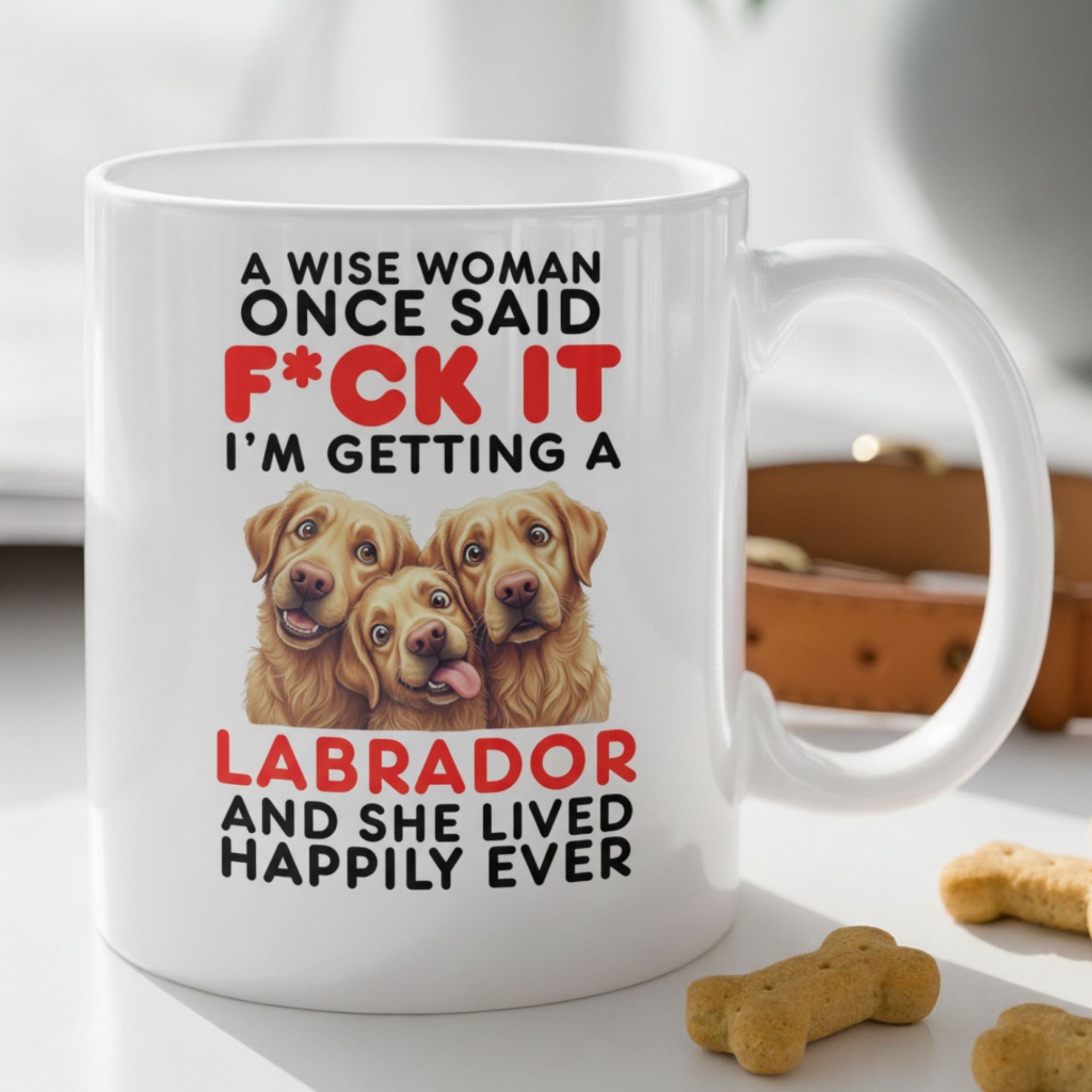 Mug with Labrador-themed text and images on a surface with dog treats.
